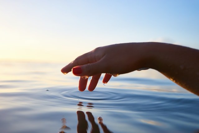 A hand touching the water