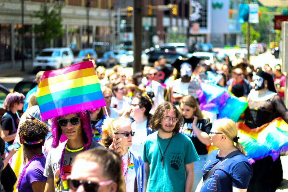 People celebrating pride month on road