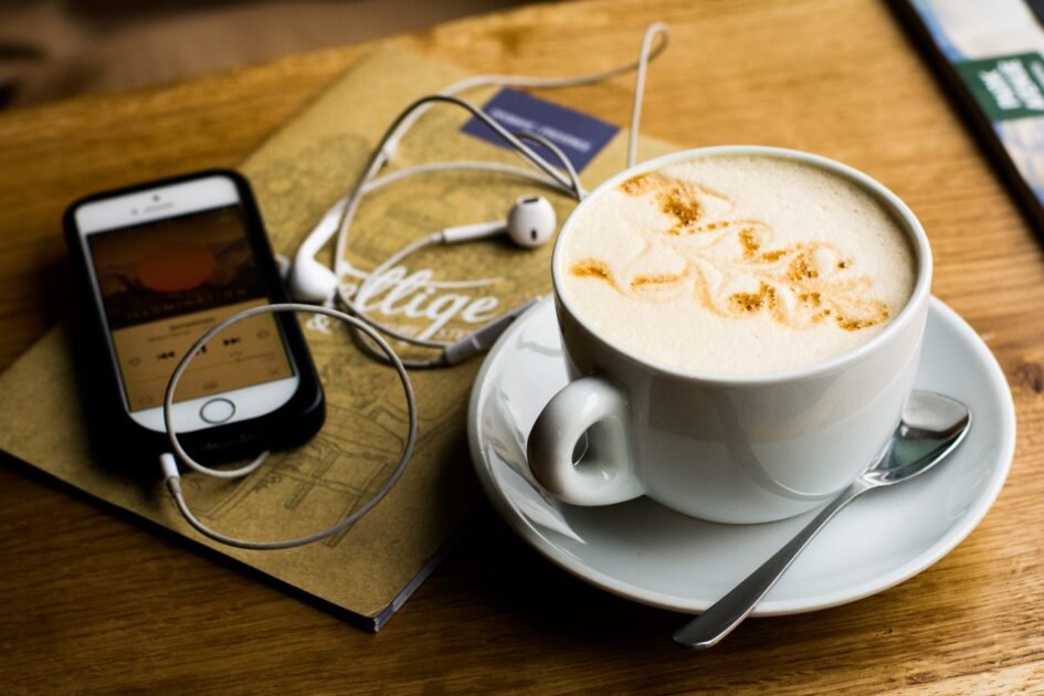 a cup of coffee with a mobile playing some music