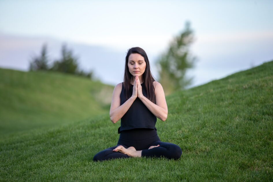 a lady meditating in a field