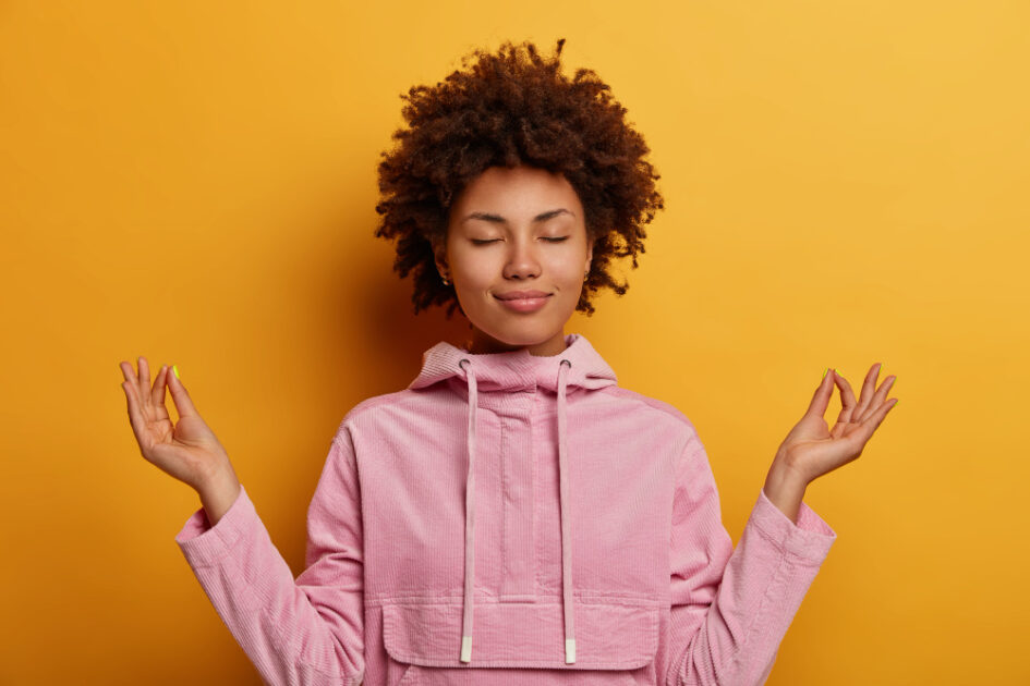 A girl with closed eyes in yoga pose