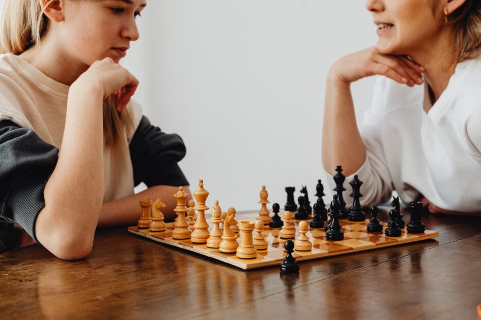 Two girls are playing chess