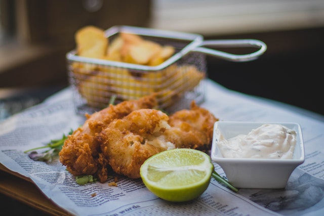 fried chicken with lemon and dip, and some chips in frier