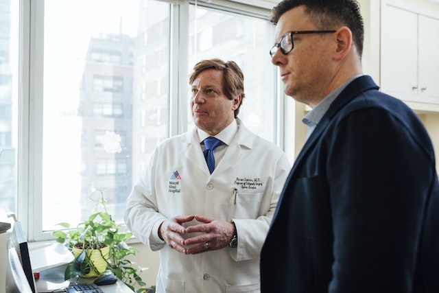 ADHD psychiatrist standing with a person in blue coat 